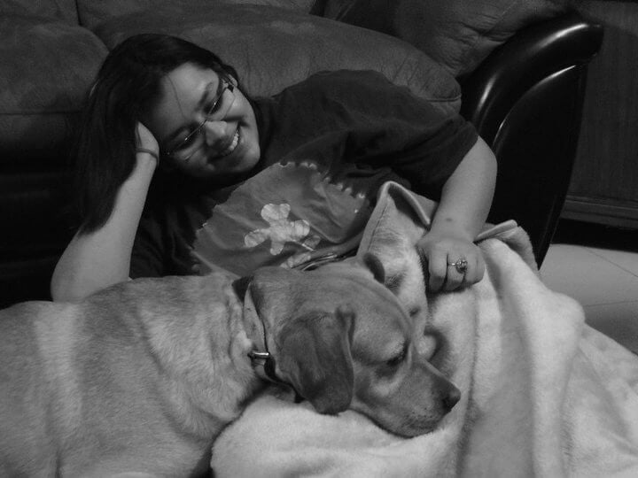 how i met my best friend - Jharna Bhatnagar cuddling her dog Ceasor on couch, his head on blanket capturing wordless best friend love.