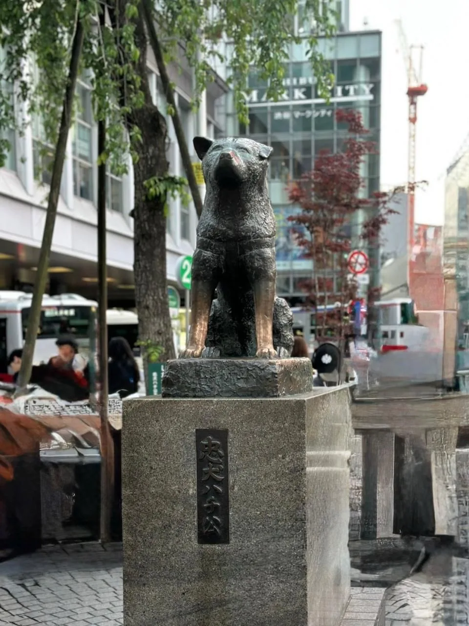 The bronze Hachiko statue outside Shibuya Station, Tokyo, with the Chuken Hachiko plaque